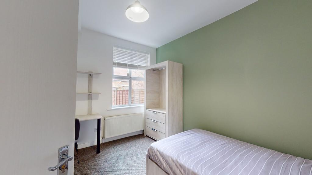 A bright and tidy double bedroom featuring a co...