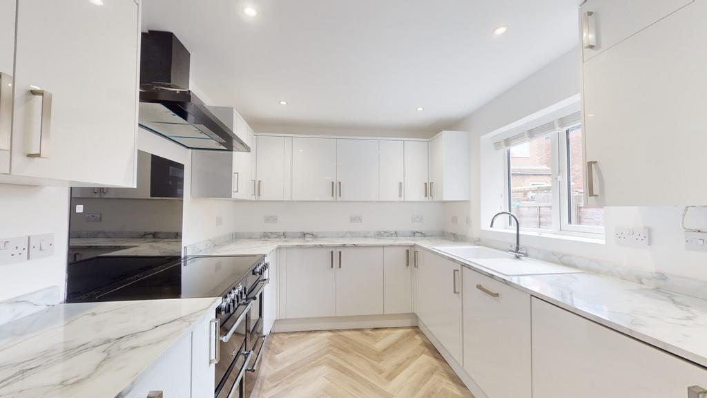 A modern and spacious kitchen featuring sleek c...