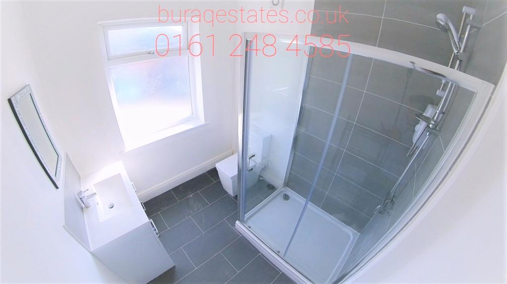 A modern bathroom suite featuring a walk-in gla...
