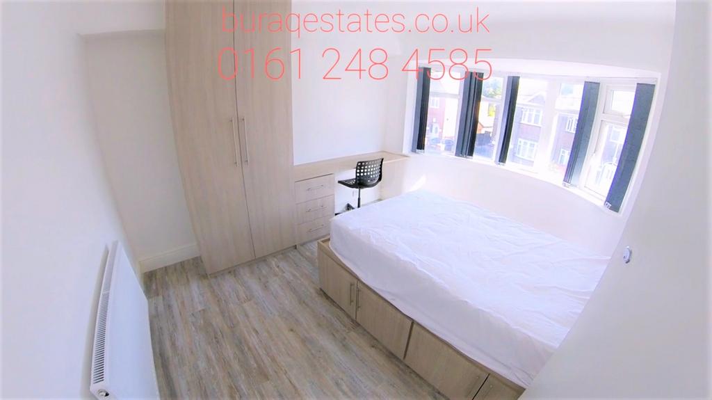 Bright double bedroom featuring a large bay win...