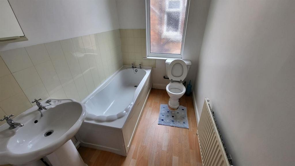 A clean and bright bathroom featuring a full-si...