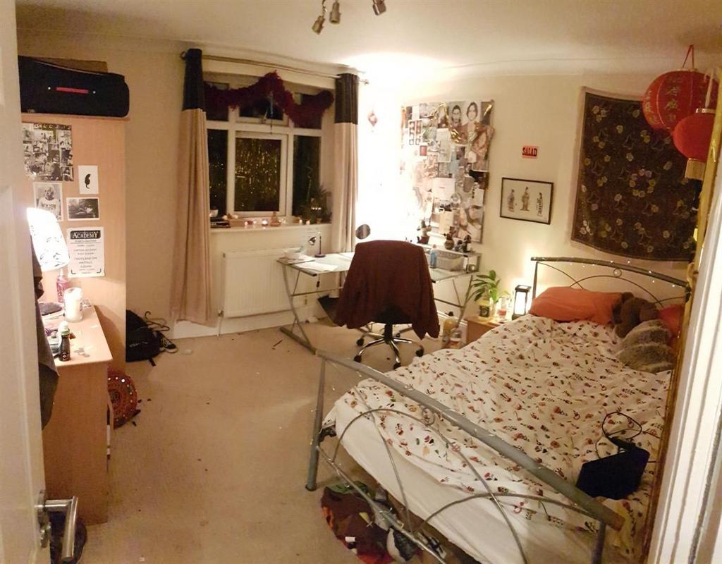 Cozy and inviting single bedroom featuring a me...