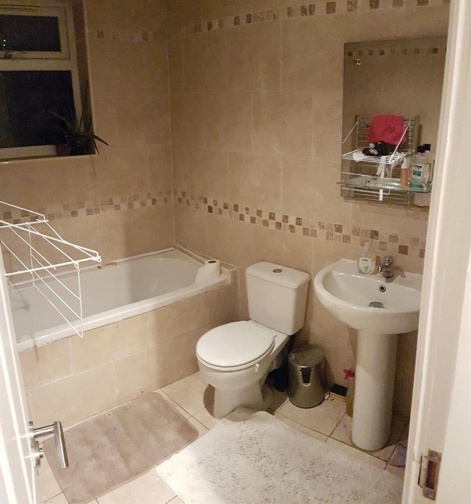 A well-maintained bathroom suite featuring a ba...