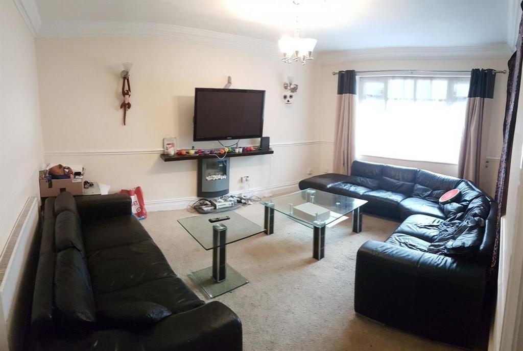 A comfortable living room featuring three black...