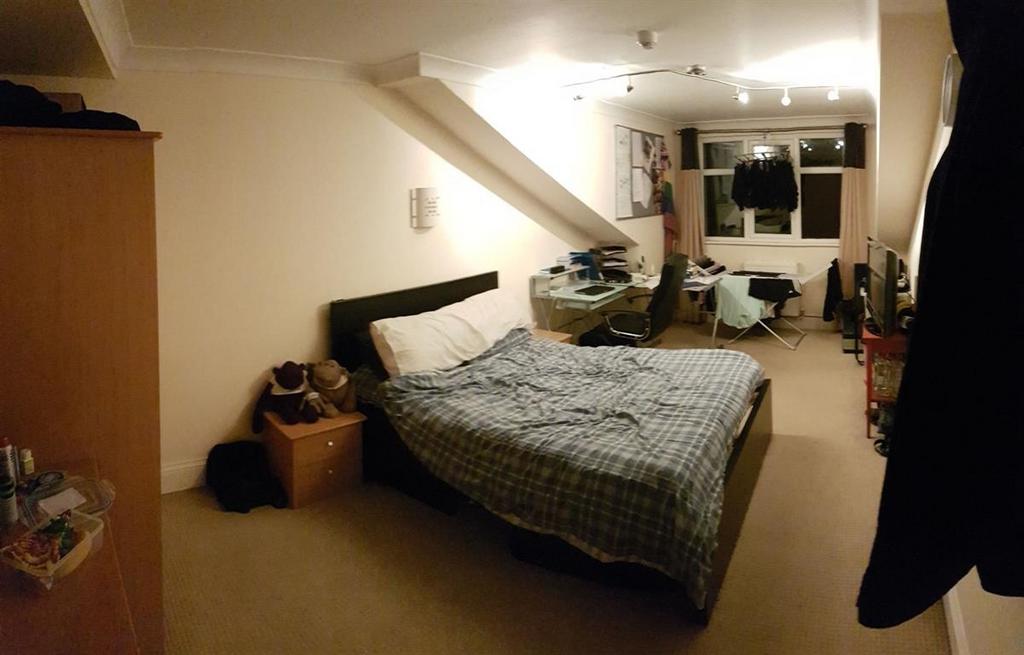 Cozy master bedroom with a double bed, desk and...