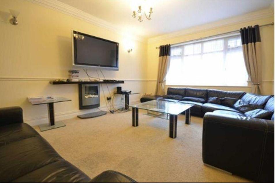 Spacious and inviting living room featuring com...