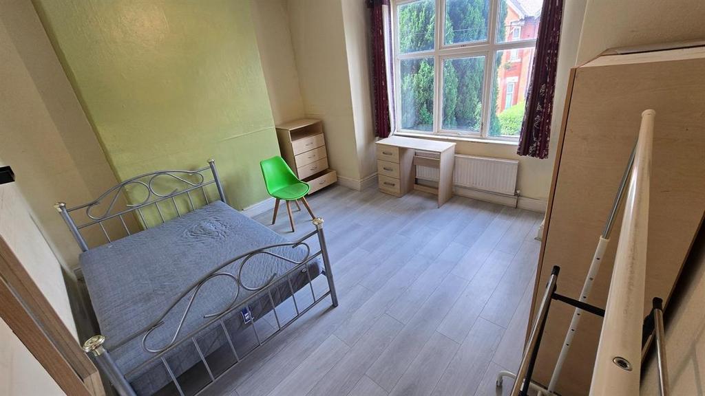 Bright and tidy double bedroom featuring a meta...