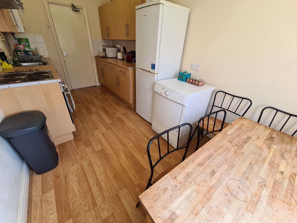 Bright and functional kitchen space featuring w...