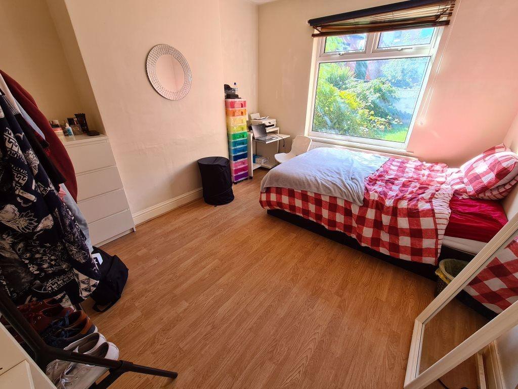 Cozy single bedroom featuring a bright window t...