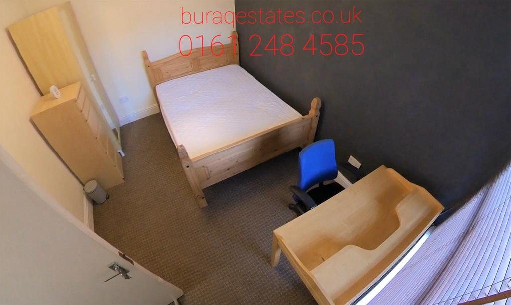 A clean and neat single bedroom featuring a woo...