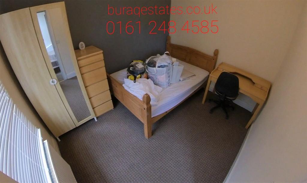 Cozy single bedroom featuring a wooden bed fram...