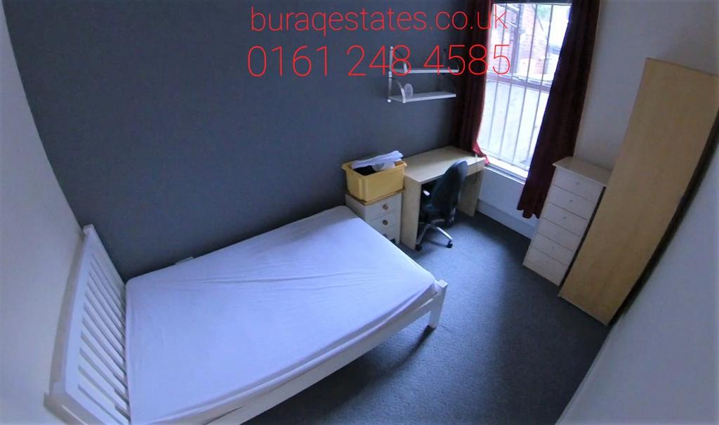 A cozy single bedroom featuring a neat bed fram...