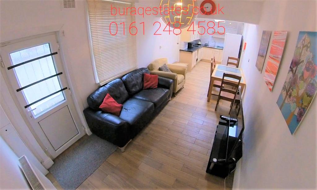 Bright, elongated living room with a black leat...
