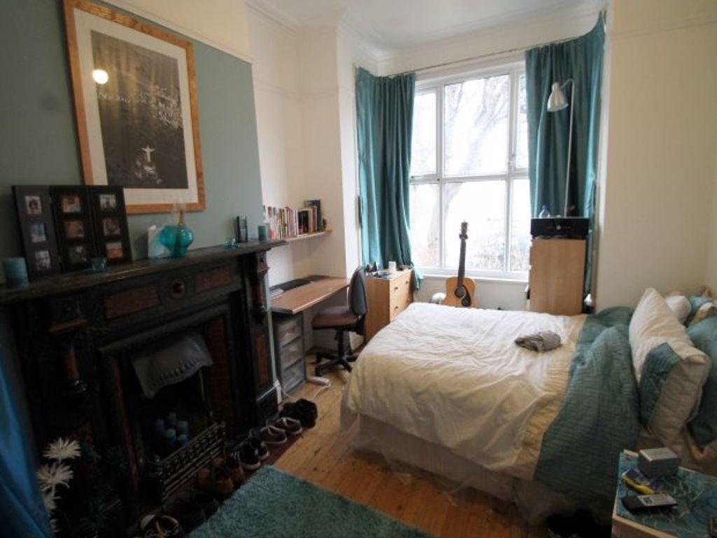 A cozy and inviting master bedroom featuring a ...