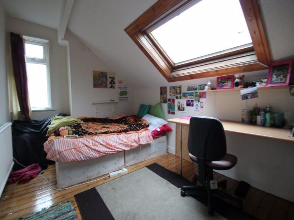 Cozy single bedroom featuring a sloped ceiling ...
