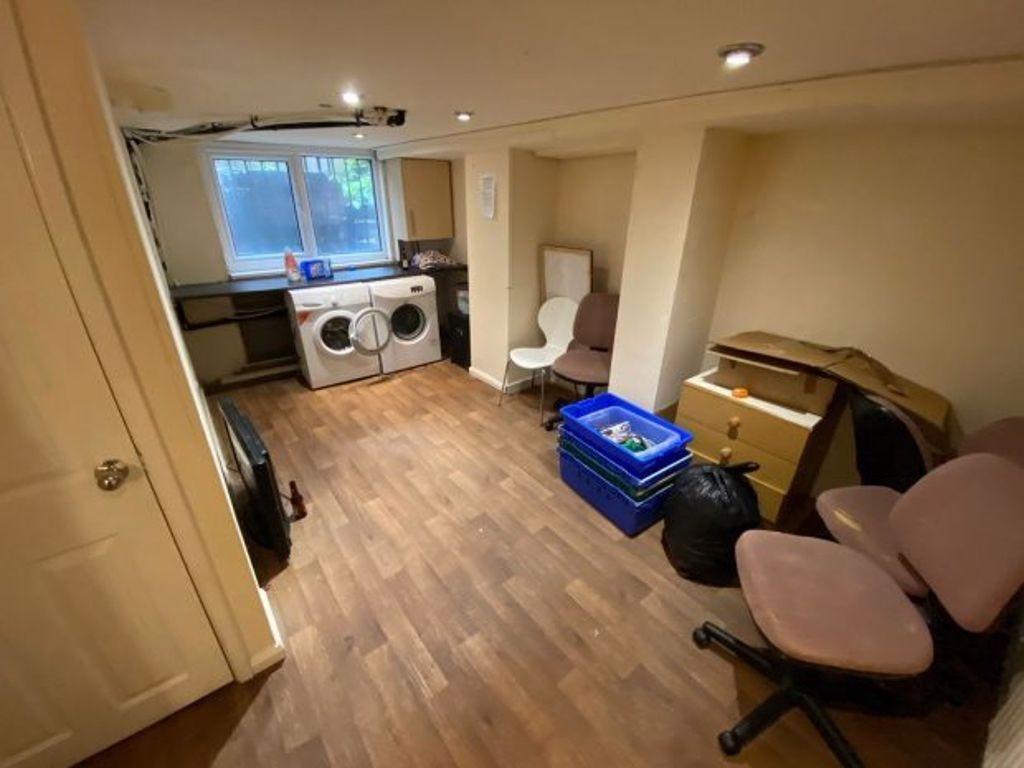 A compact kitchen space with wooden flooring an...