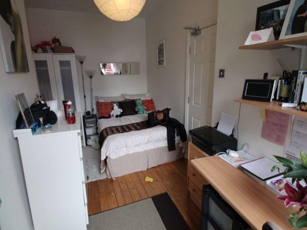 A cozy and well-organized single bedroom featur...