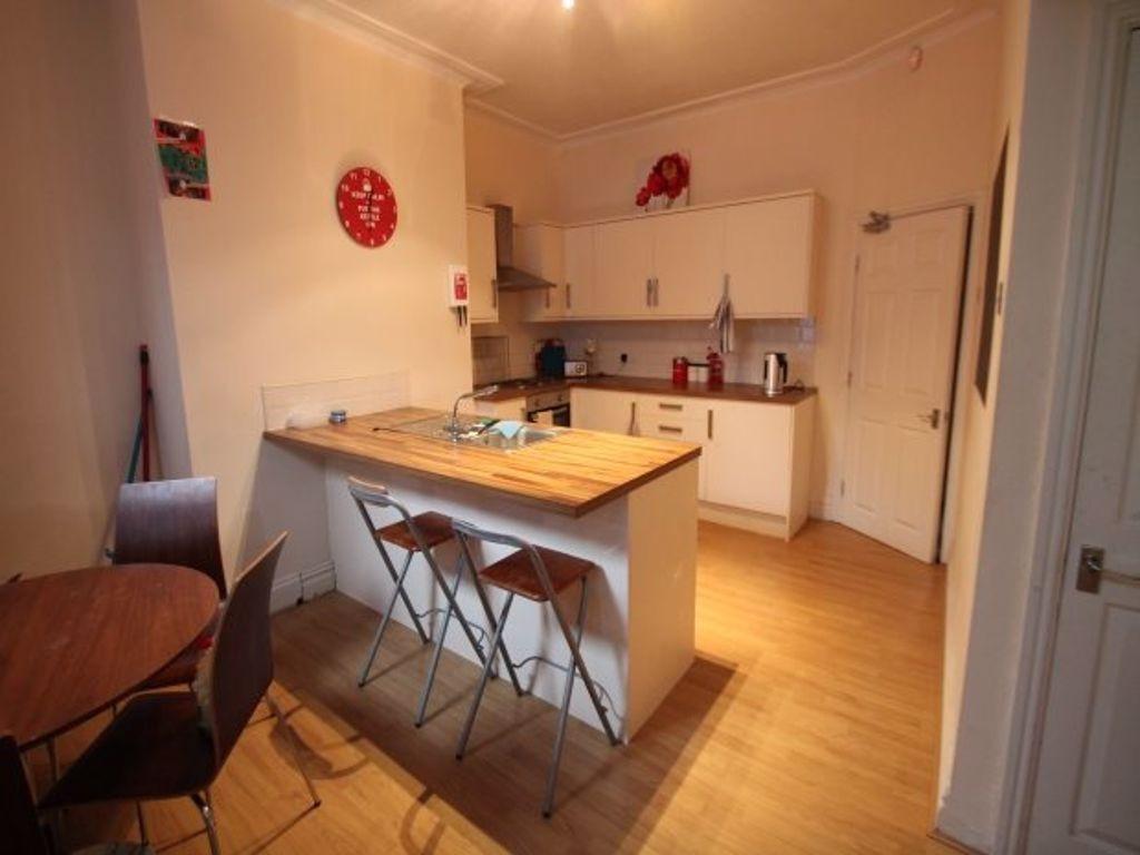 Bright and tidy kitchen with a wooden breakfast...
