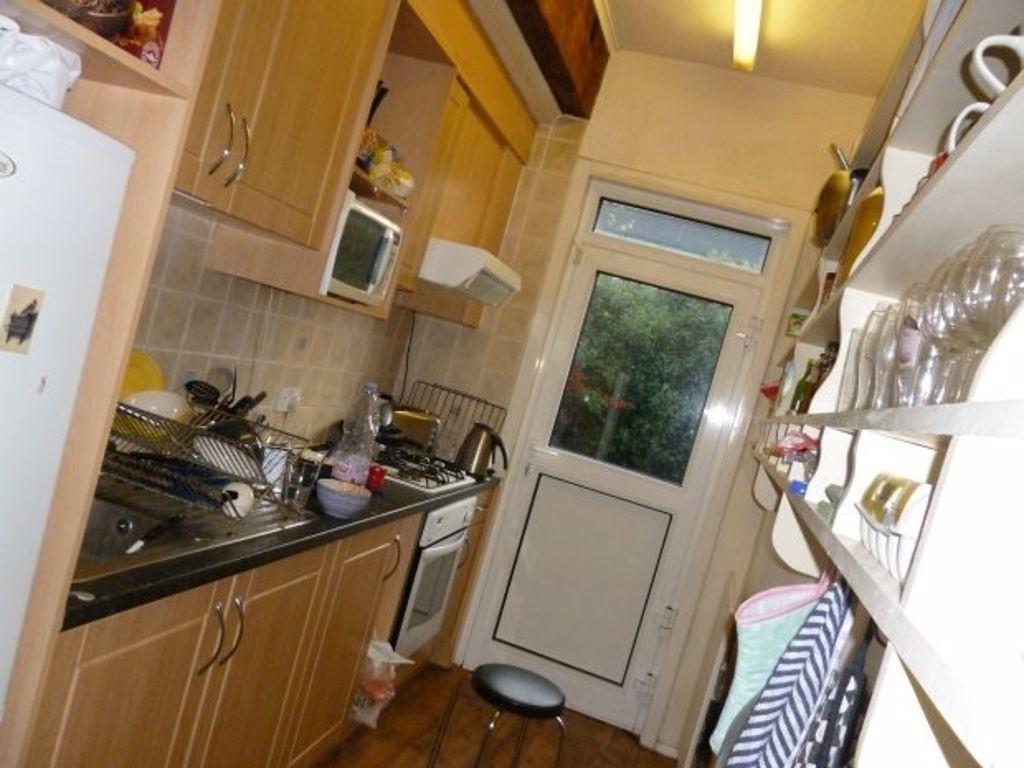 A well-maintained kitchen with wooden cabinets,...