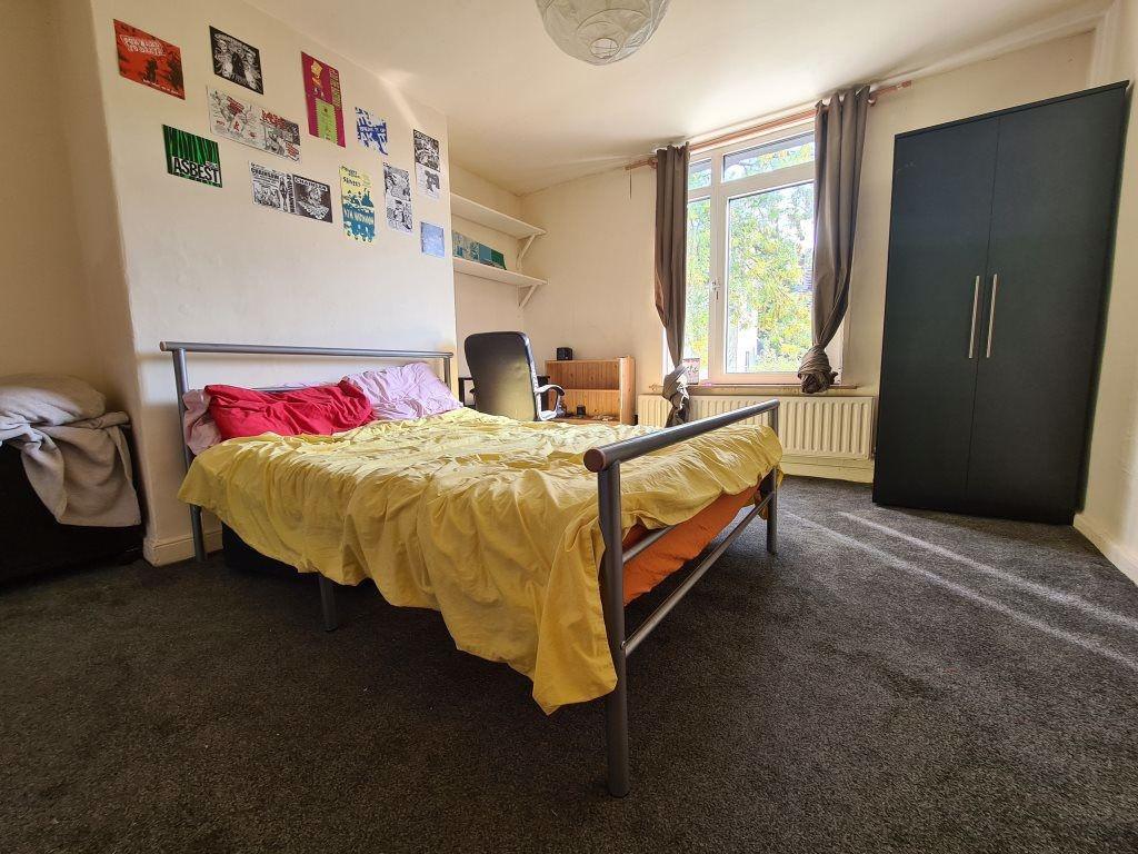 A spacious double bedroom featuring a comfortab...