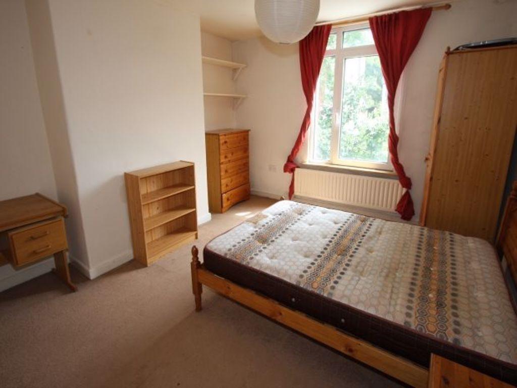 A comfortable student bedroom featuring a woode...