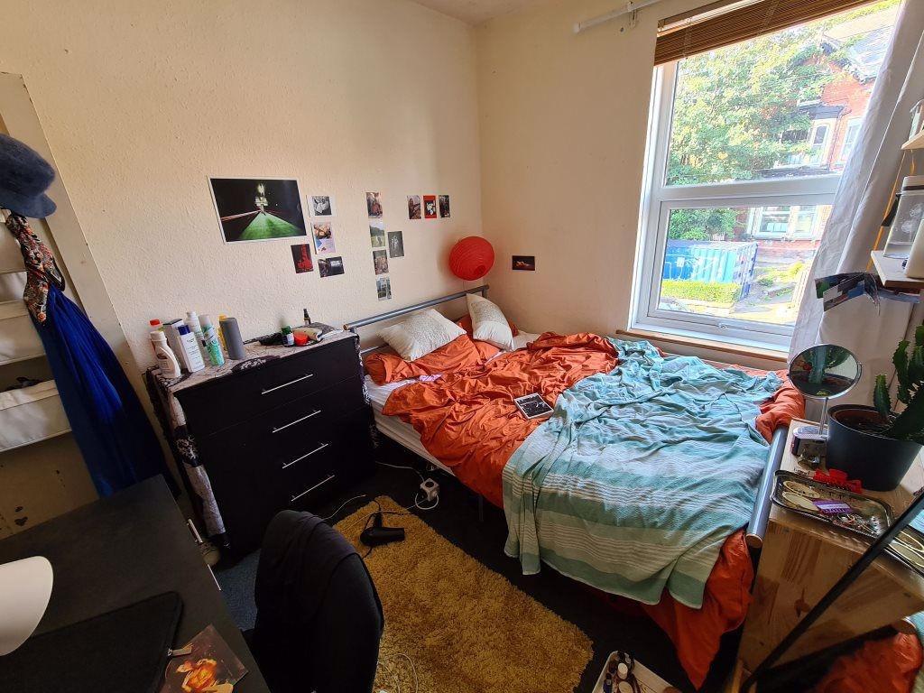 A cozy bedroom featuring a double bed with colo...