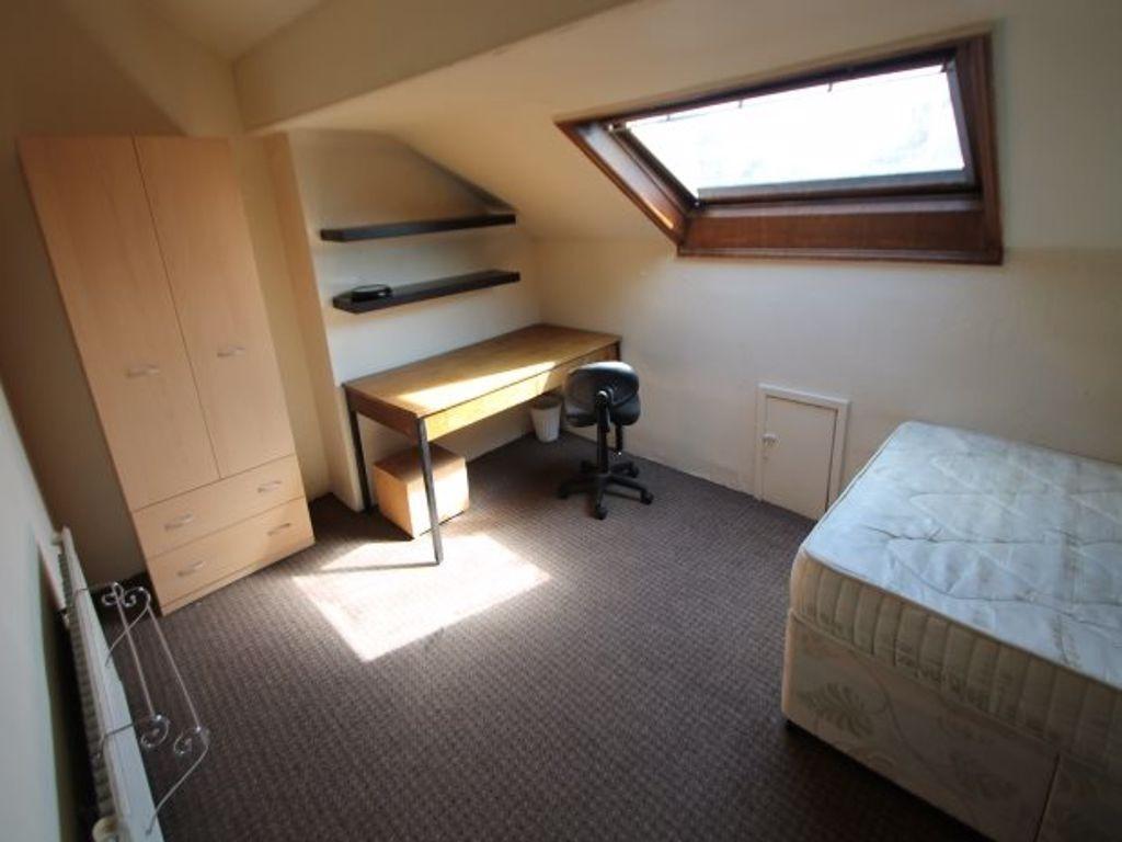 A cozy bedroom featuring a single bed, a work d...