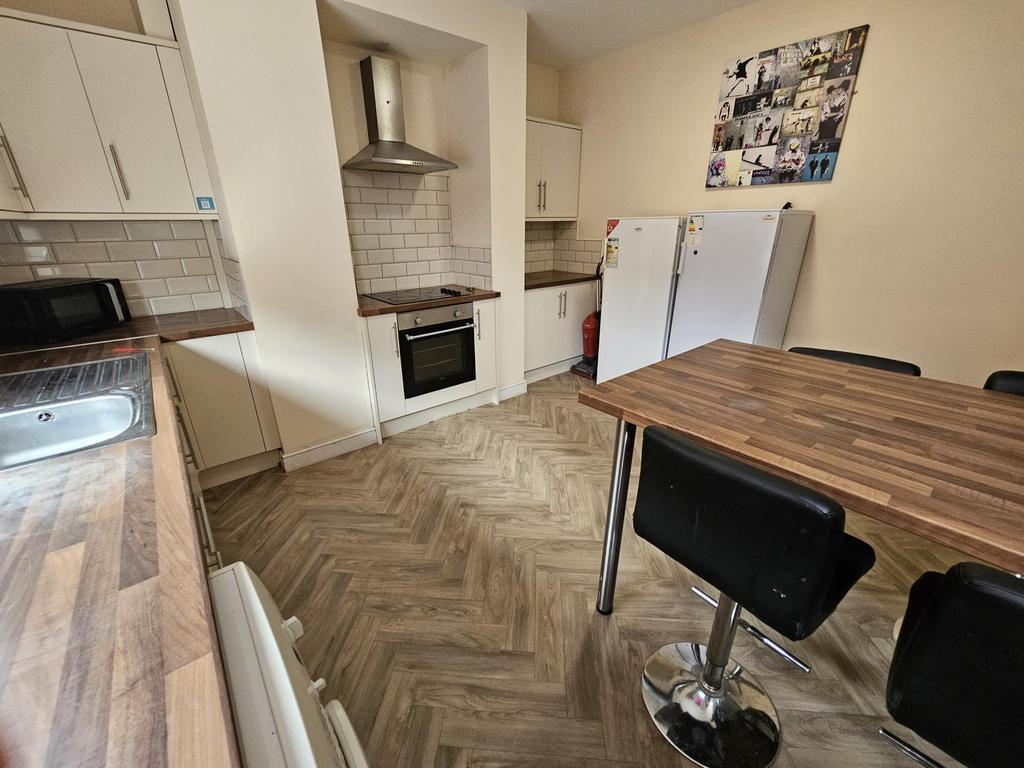 A well-maintained kitchen area with modern appl...