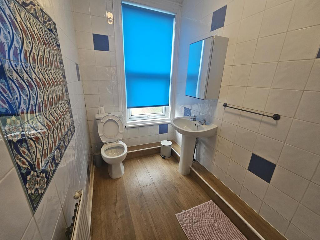 Bright and clean bathroom with a large window, ...