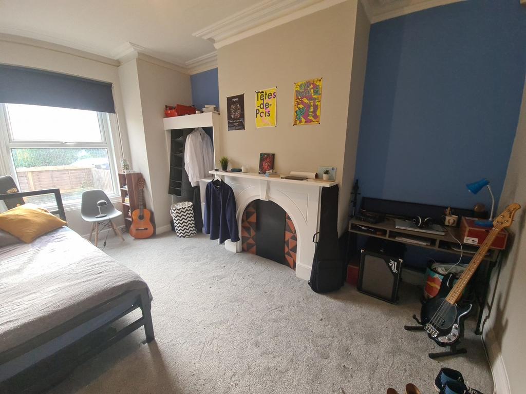 A spacious and inviting master bedroom featurin...
