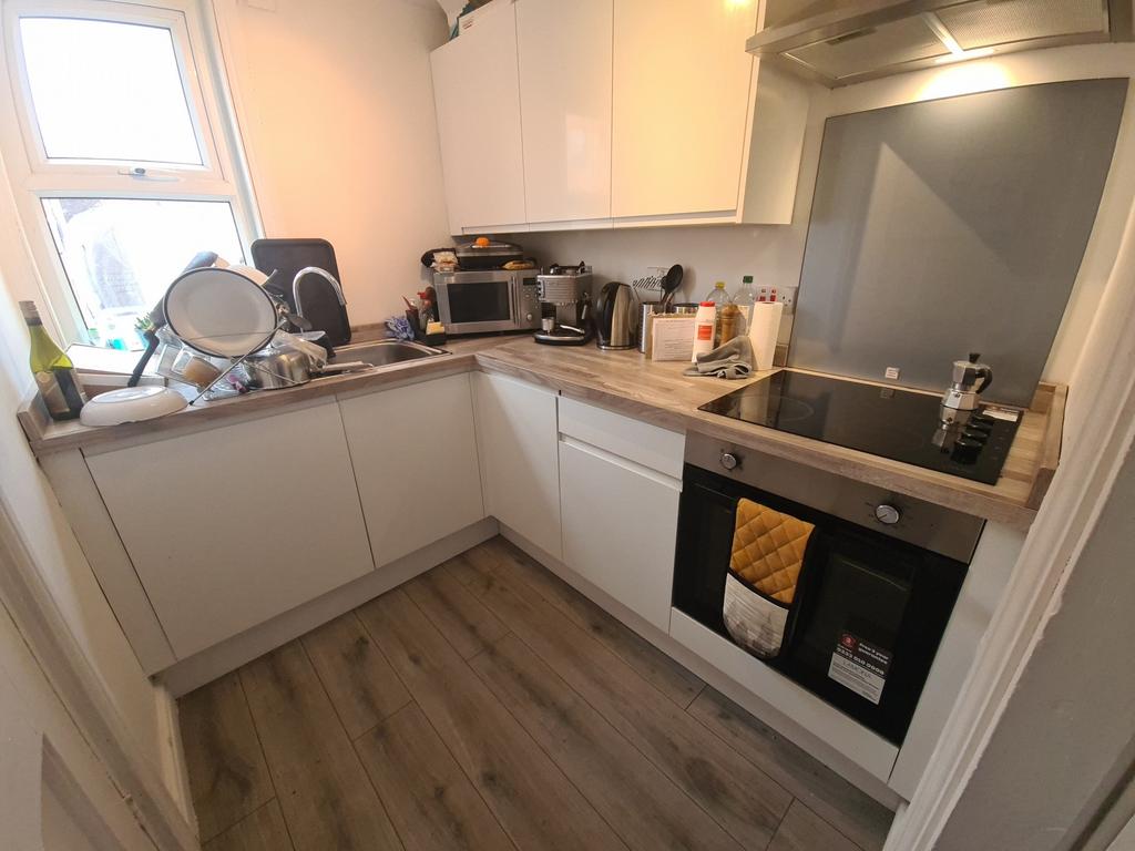 Bright and modern kitchen featuring sleek white...