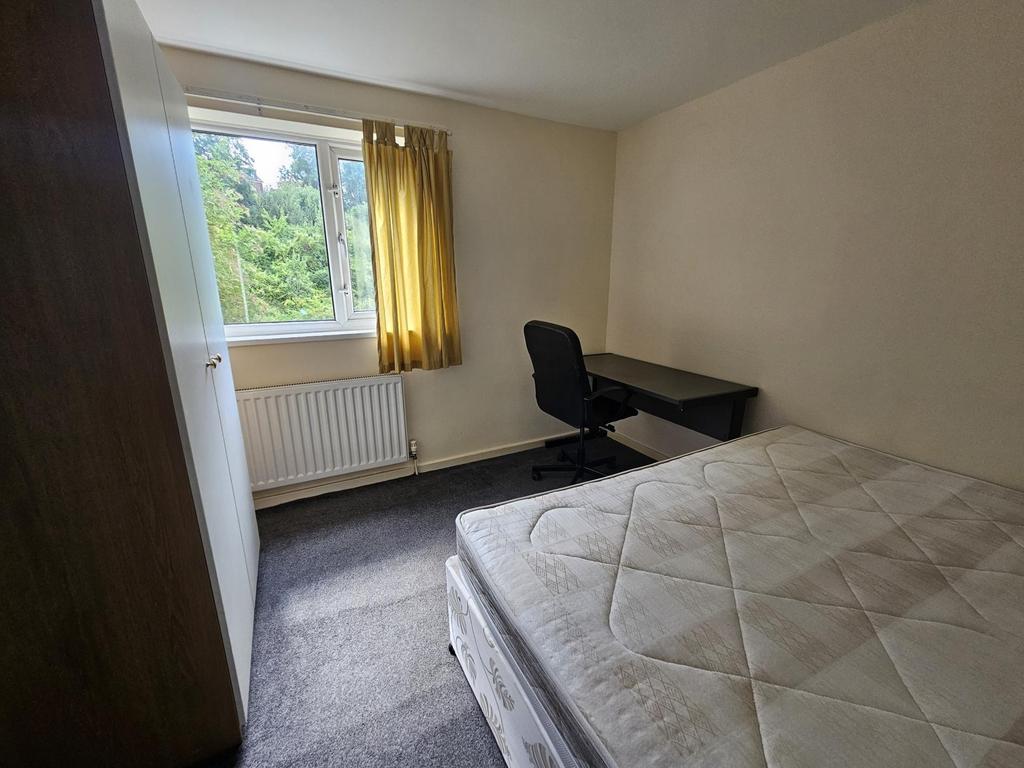 A well-lit single bedroom with a window letting...