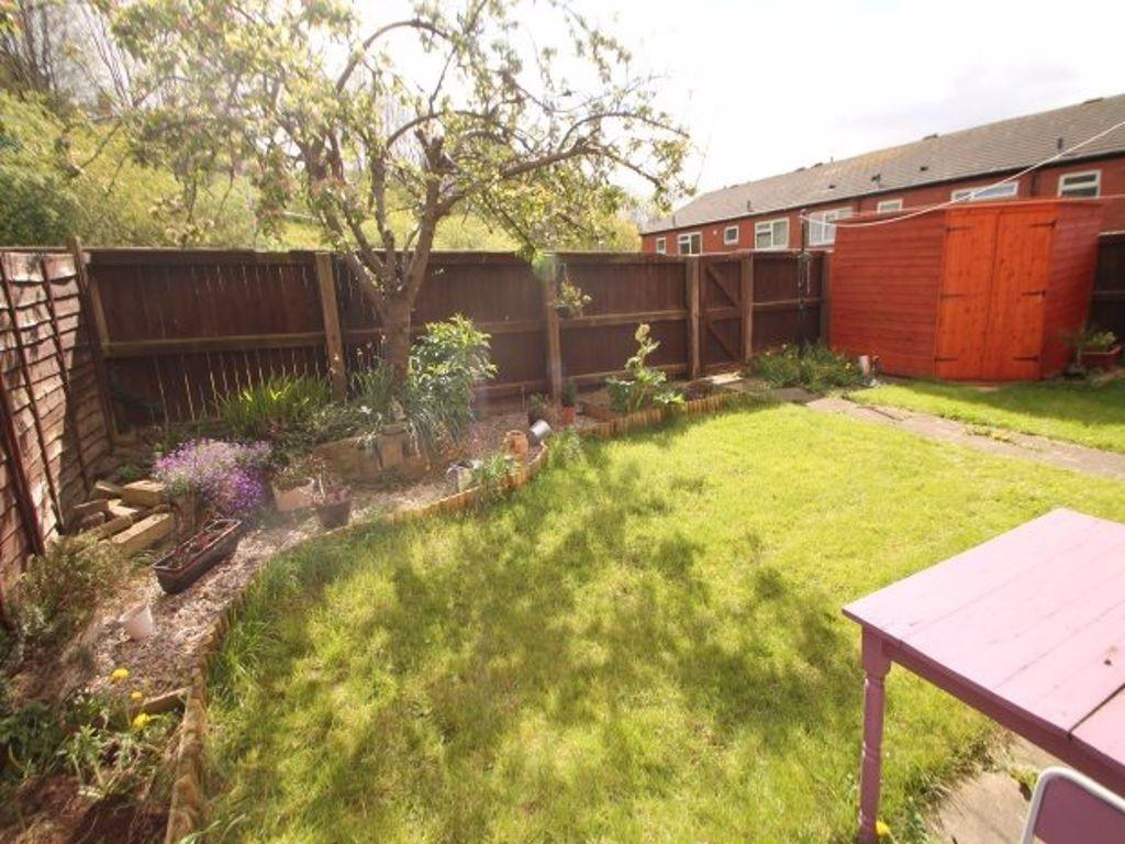 A well-maintained, sunny garden area featuring ...