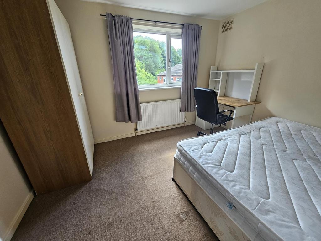 A bright, well-maintained bedroom featuring a c...