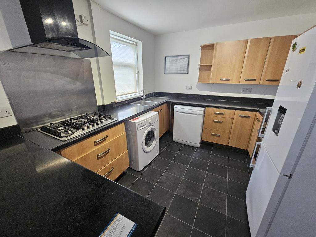A modern kitchen with well-maintained wooden ca...