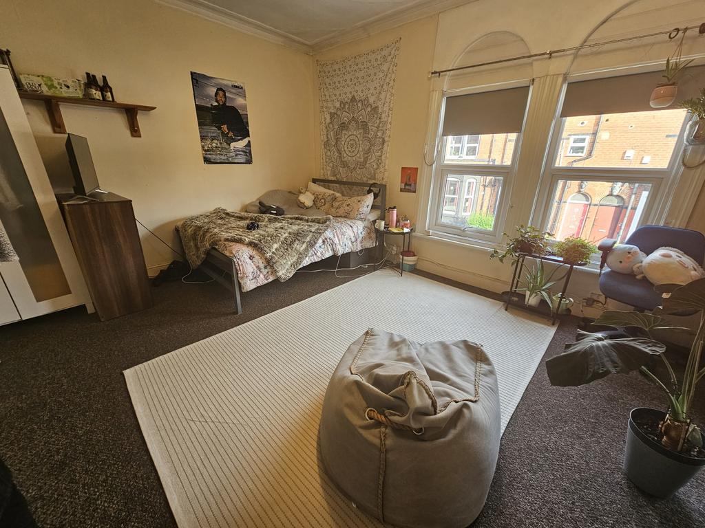 Bright and spacious bedroom featuring a comfort...