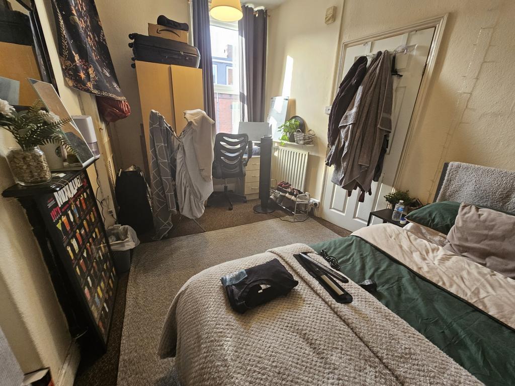 A cozy master bedroom featuring a comfortable d...