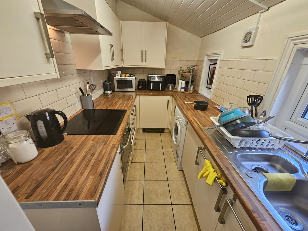 A tidy and modern kitchen featuring wooden coun...