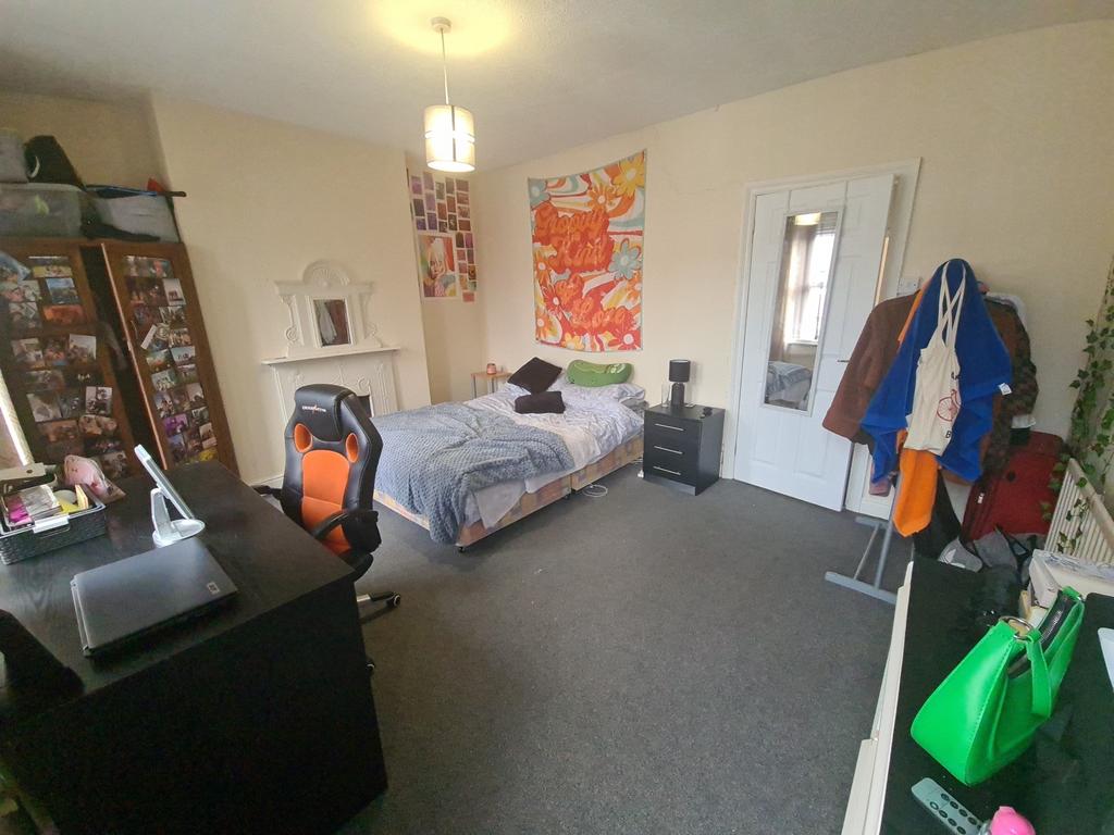 A cozy single bedroom featuring a neatly made s...