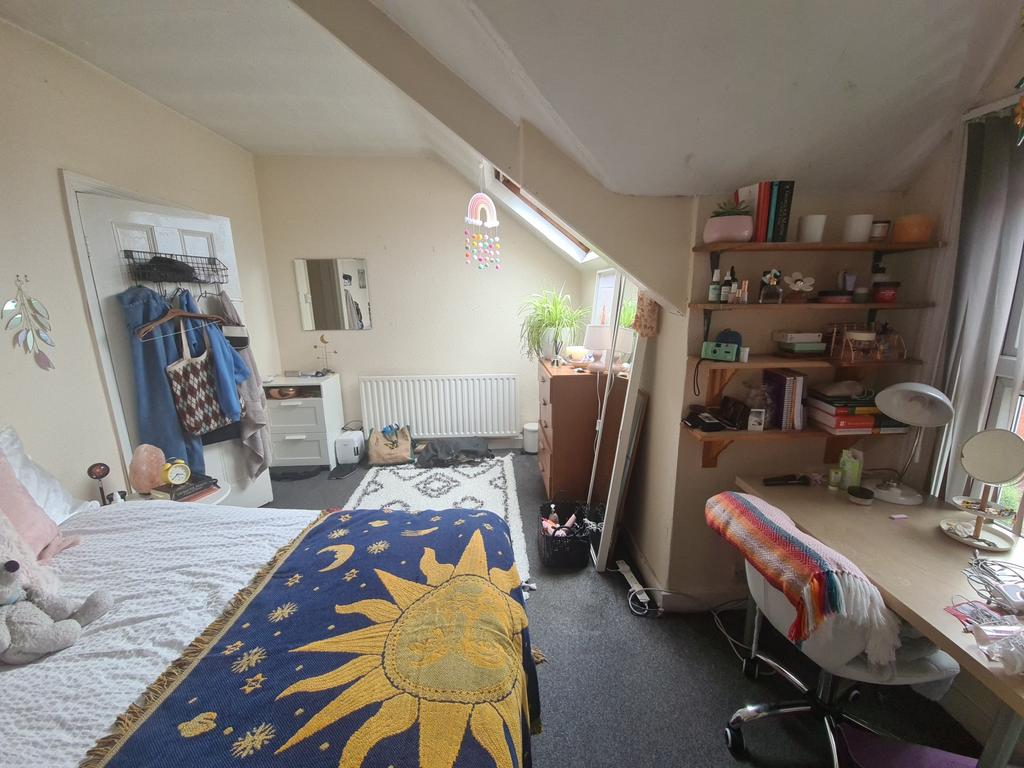 Bright and cozy student bedroom with a cheerful...