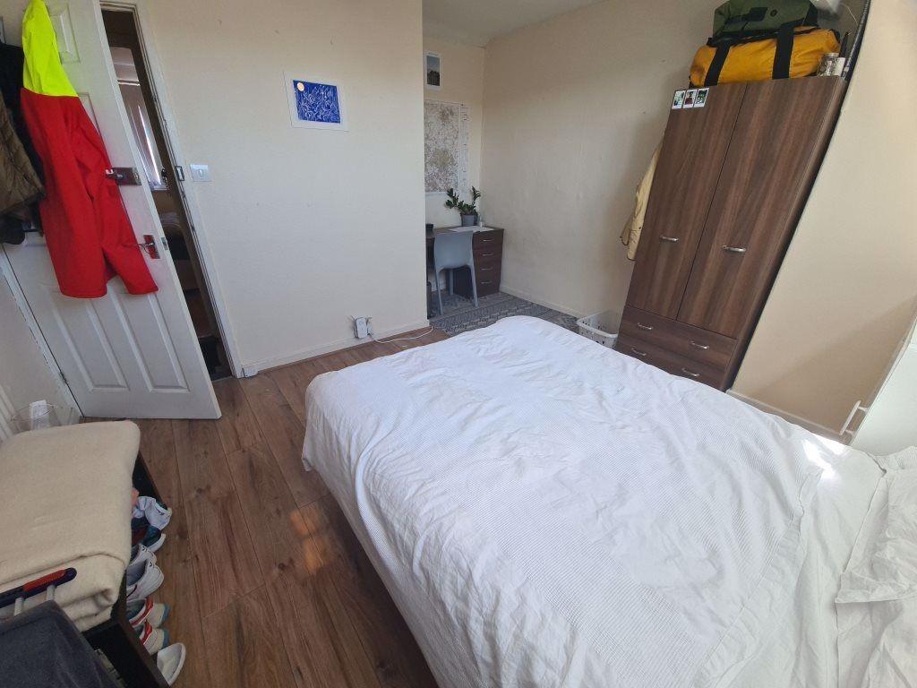 A bright, well-maintained master bedroom featur...