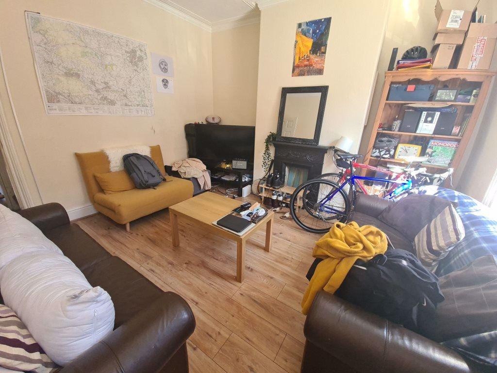 A well-lit, inviting living room with comfortab...
