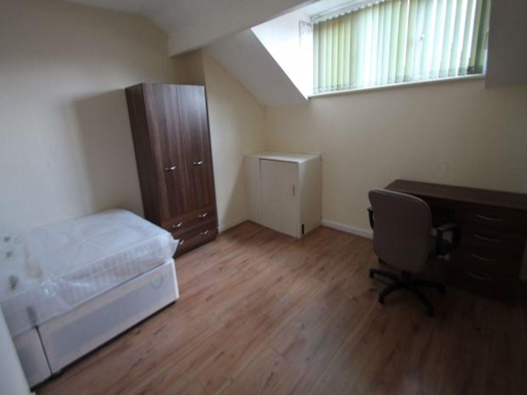 A cozy single bedroom featuring a comfortable b...
