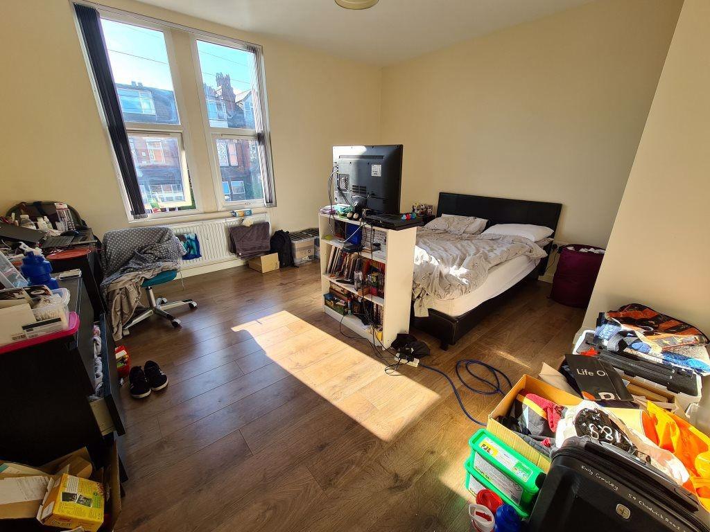 A bright double bedroom featuring a large windo...