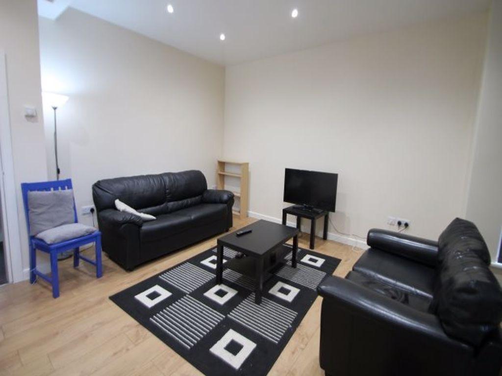 A cozy living room featuring two black leather ...