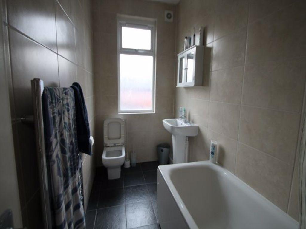 A bright, modern bathroom suite featuring a ful...