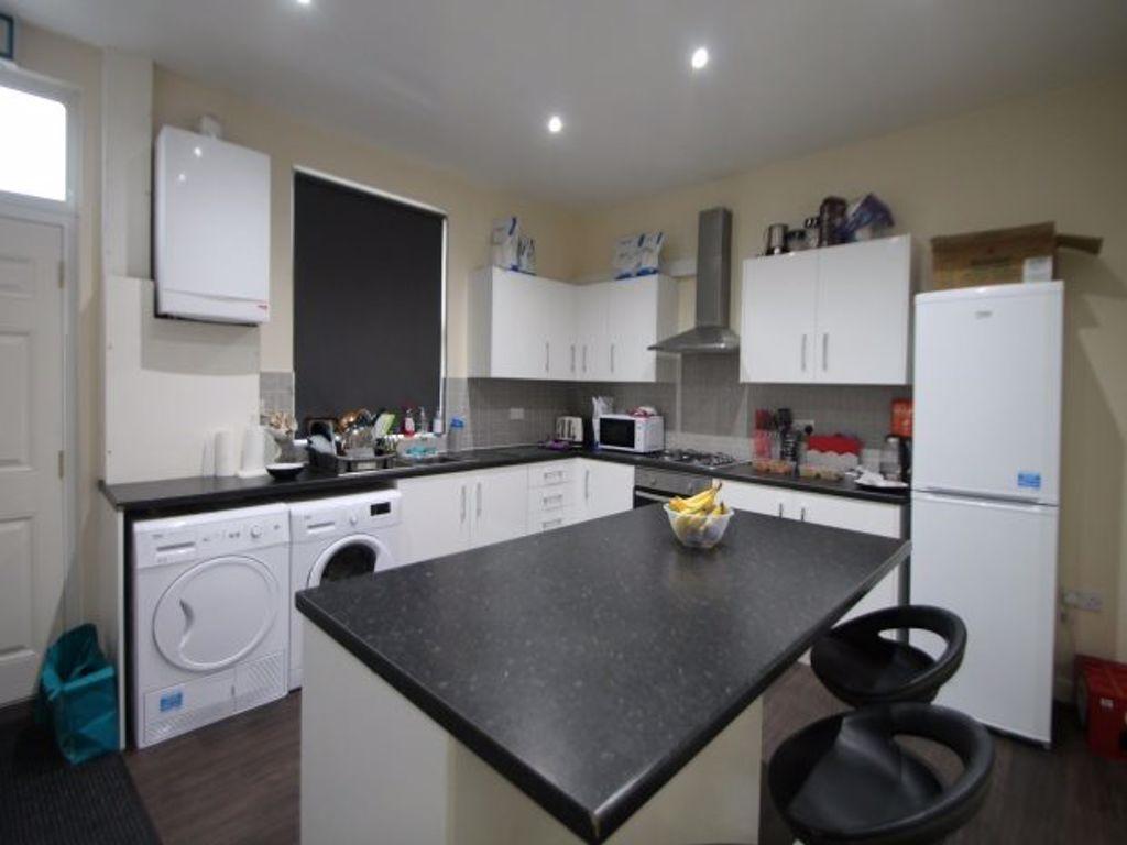 Modern kitchen featuring a central island with ...