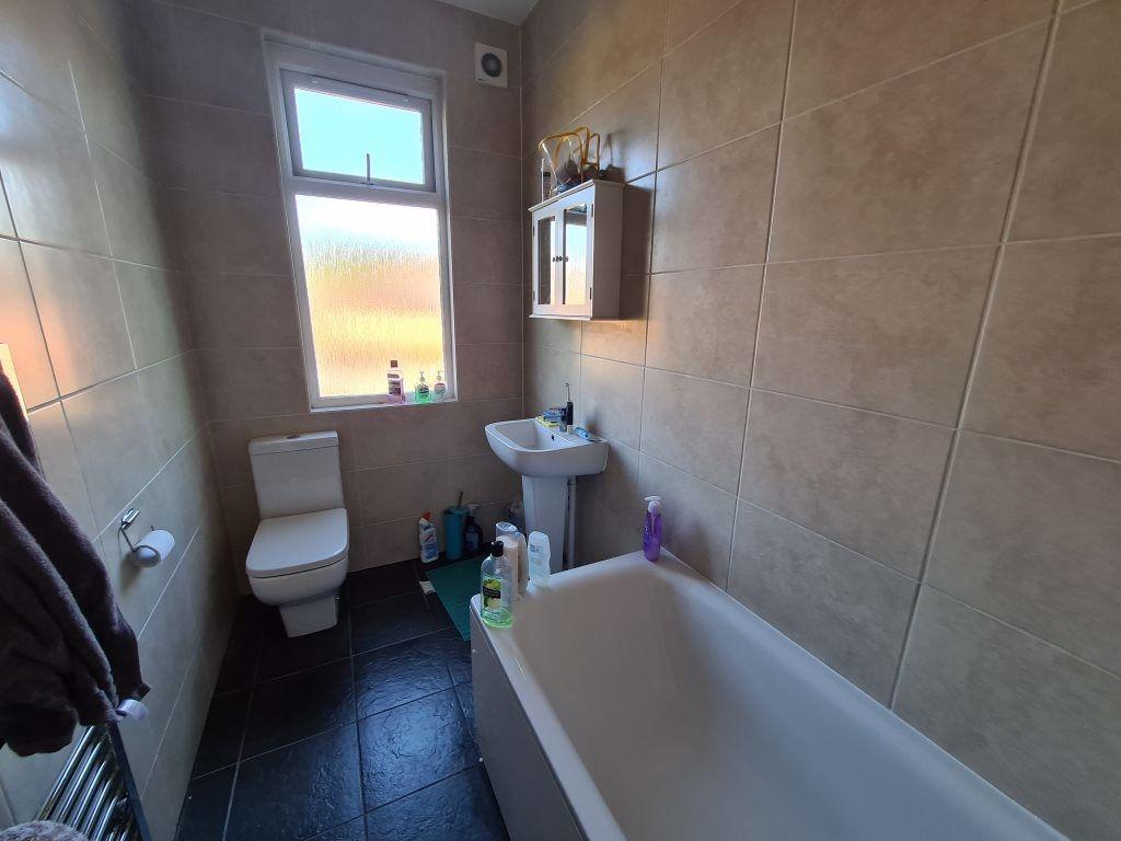 A clean and modern bathroom featuring a white b...
