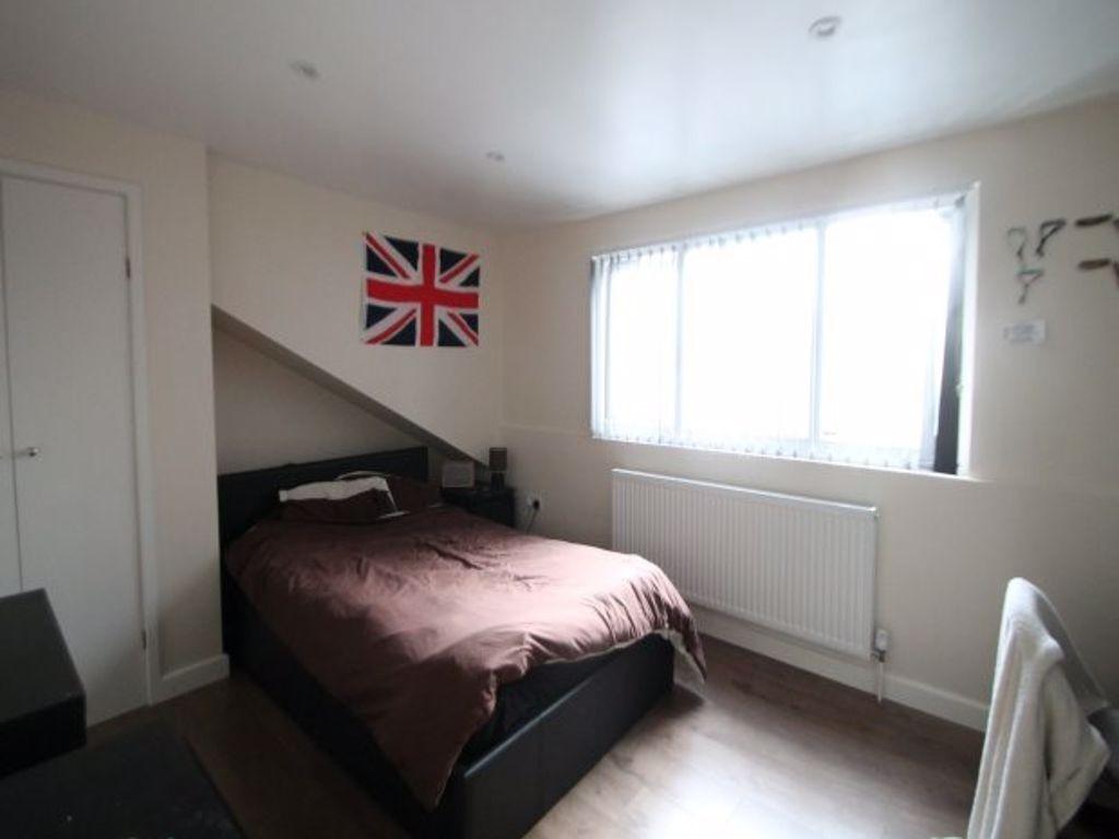 Cozy bedroom with a large window allowing ample...