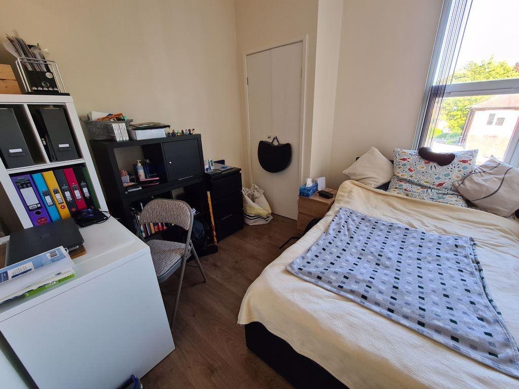 Cozy single bedroom featuring a comfortable bed...